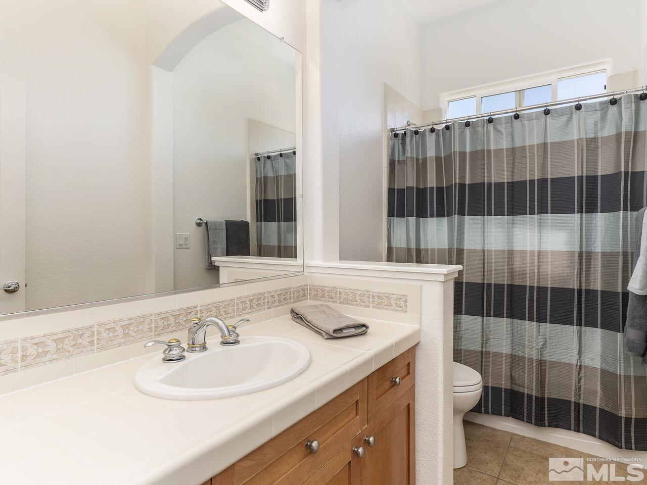 895 Peacepipe Loop Reno, NV 89511 - Photo 21 of 37 a bathroom with a sink double vanity and shower