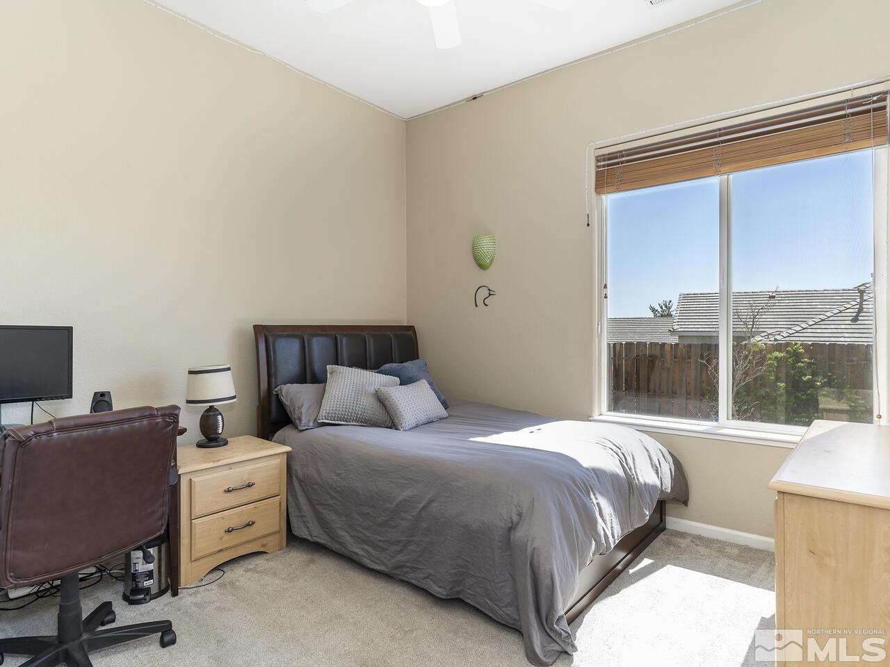 895 Peacepipe Loop Reno, NV 89511 - Photo 22 of 37 a bedroom with a bed and large windows