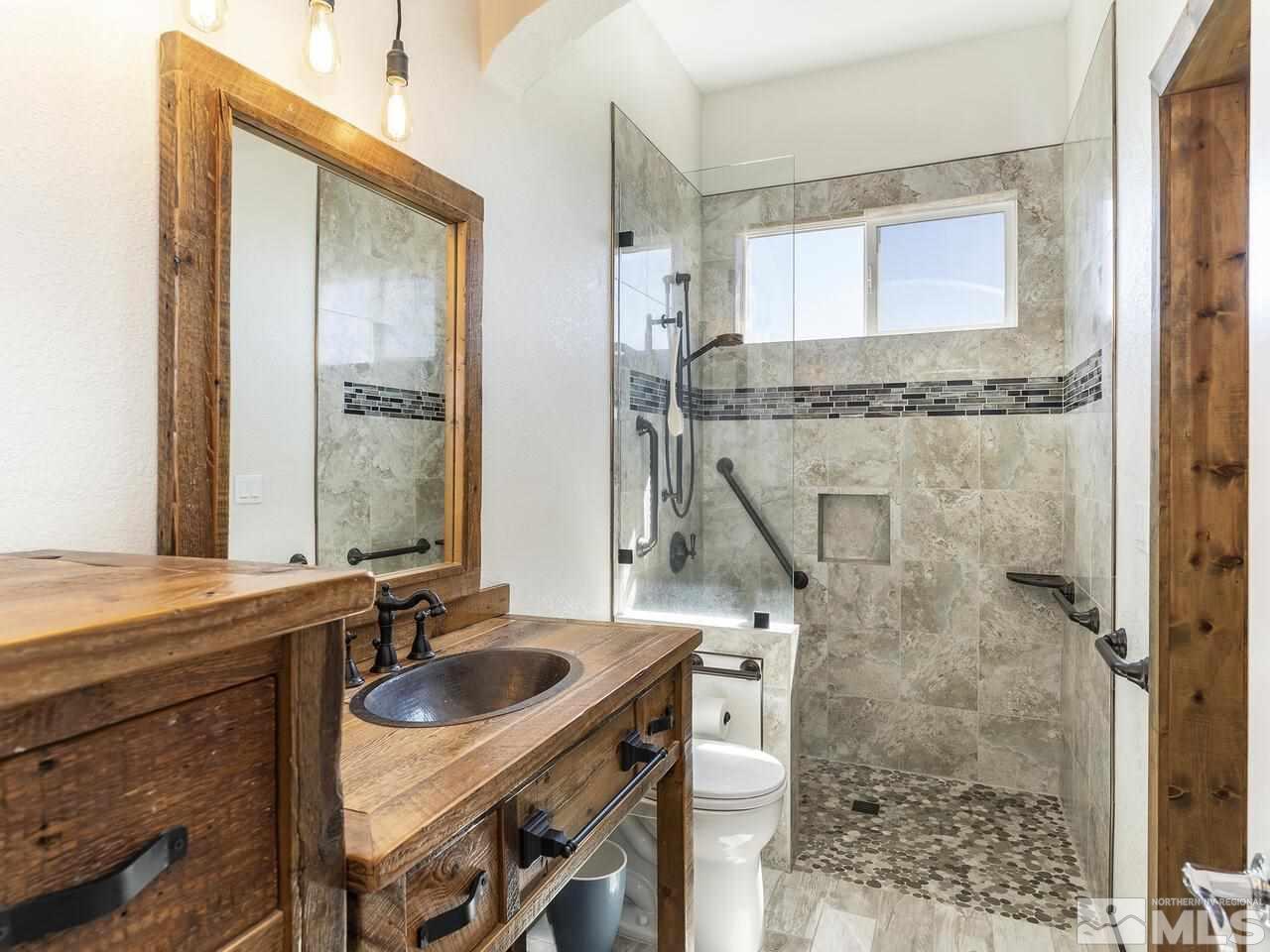 895 Peacepipe Loop Reno, NV 89511 - Photo 23 of 37 a bathroom with a sink and a mirror