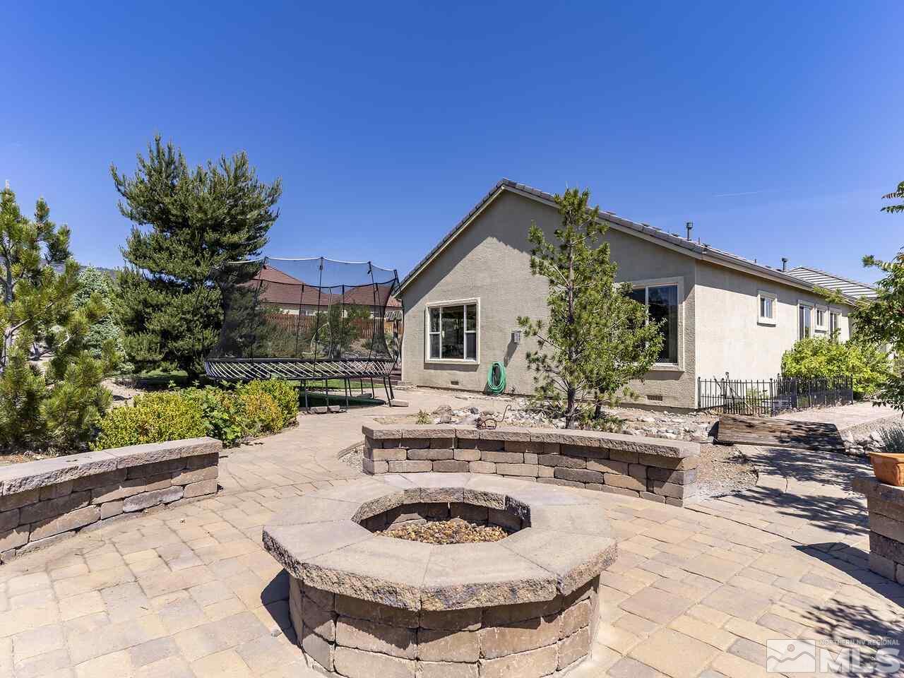 895 Peacepipe Loop Reno, NV 89511 - Photo 30 of 37 a swimming pool with outdoor seating and yard
