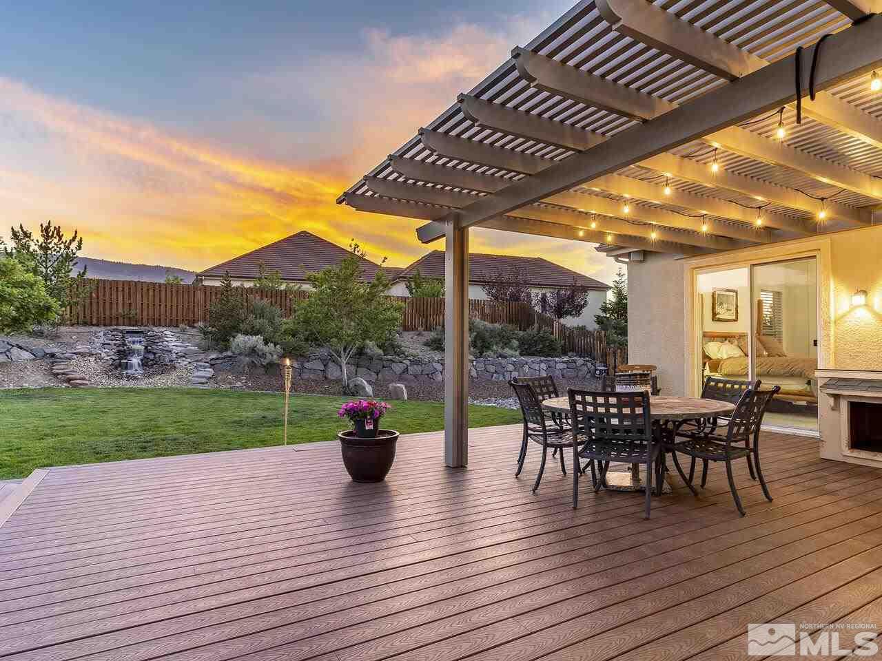 895 Peacepipe Loop Reno, NV 89511 - Photo 34 of 37 a view of a patio with dining table and chairs with wooden floor