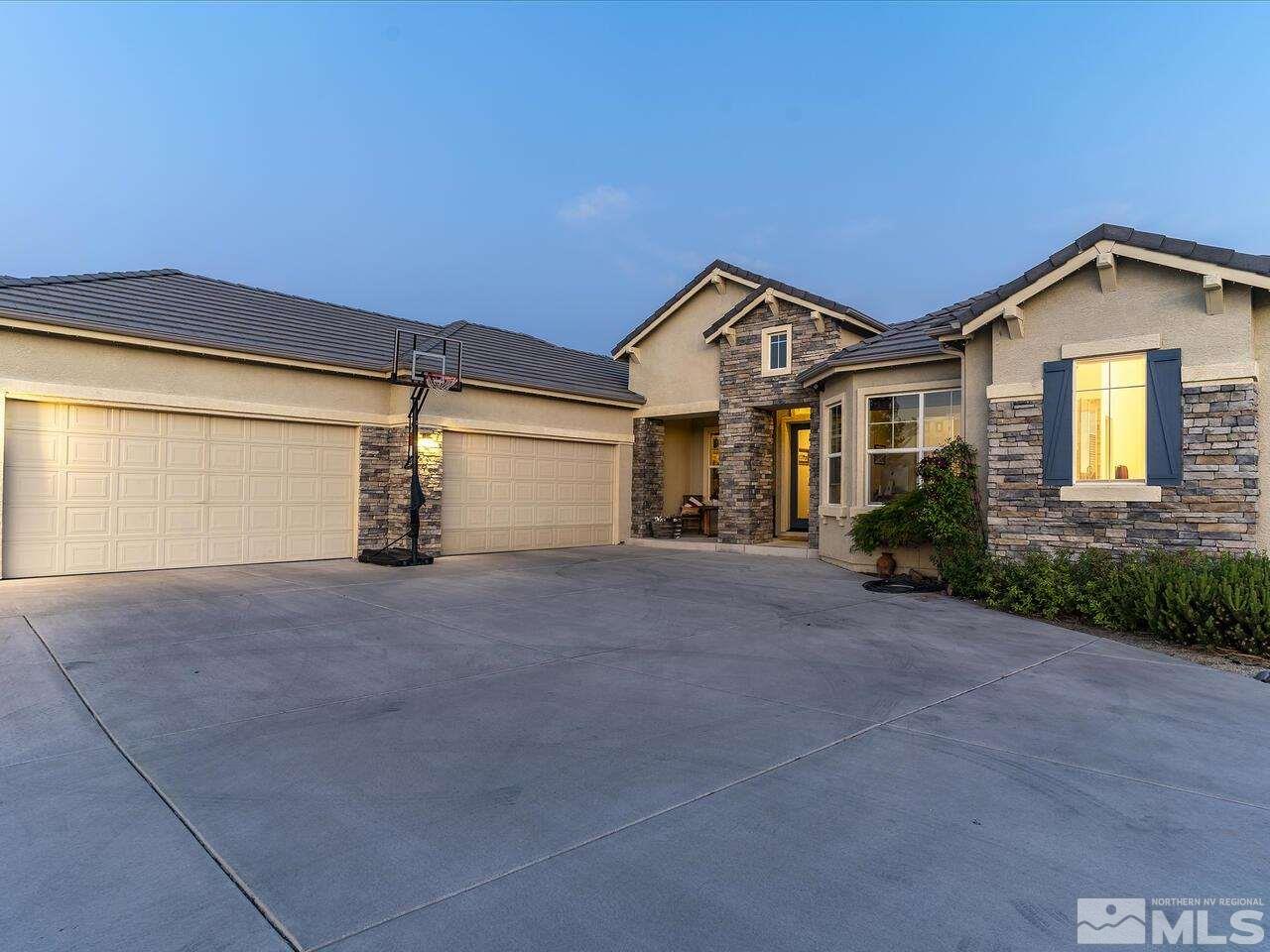 895 Peacepipe Loop Reno, NV 89511 - Photo 5 of 37 a view of a house with a yard and garage