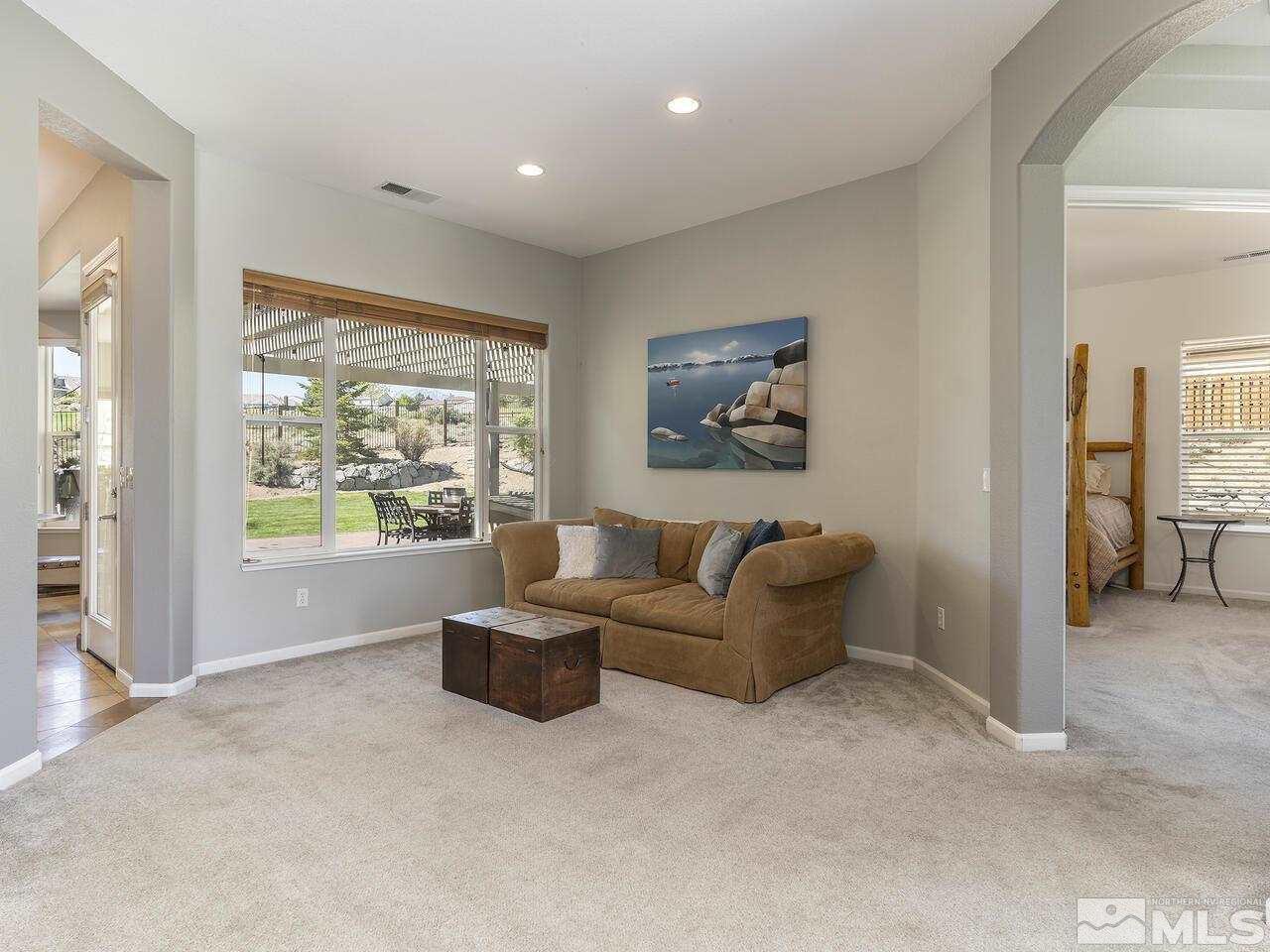 895 Peacepipe Loop Reno, NV 89511 - Photo 9 of 37 a living room with furniture and a large window