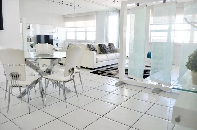 a living room with furniture a flat screen tv and a large window