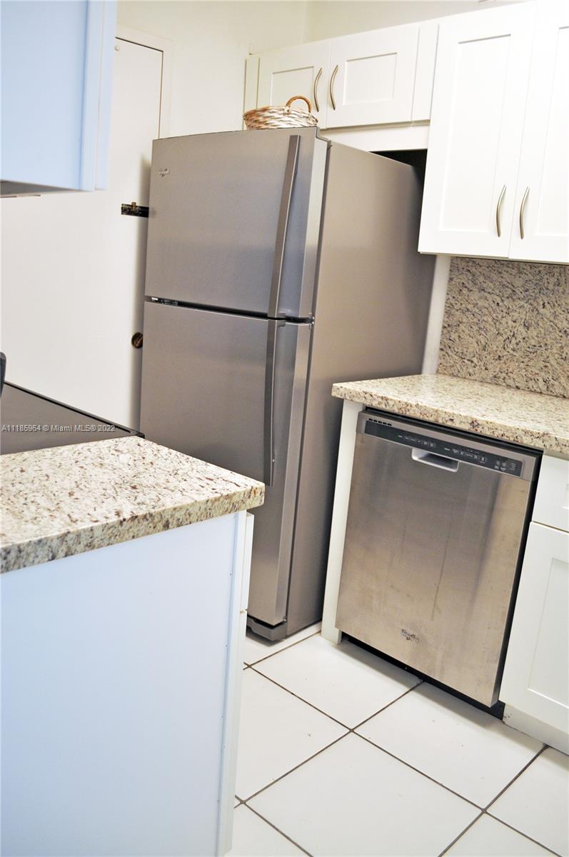 100 Lincoln Road, Unit 910 Miami Beach, FL 33139 - Photo 4 of 10 a utility room with refrigerator washer and dryer