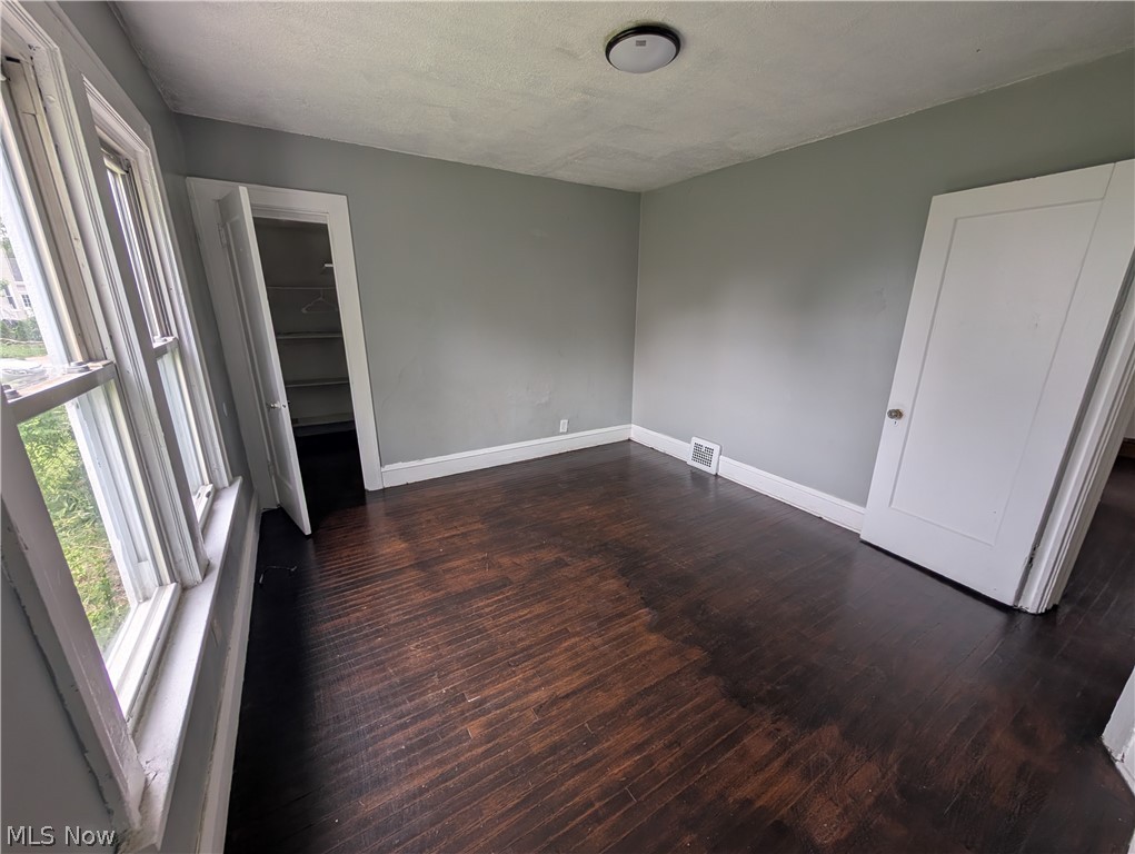 475 East 146th Street Cleveland, OH 44110 - Photo 13 of 28 Room with wood-finish flooring, light gray walls, and white trim