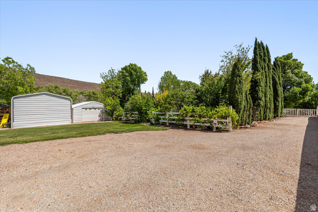 246 West Mount Charm Road Toquerville, UT 84774 - Photo 43 of 70 View of yard with an outdoor structure, a garage, and driveway