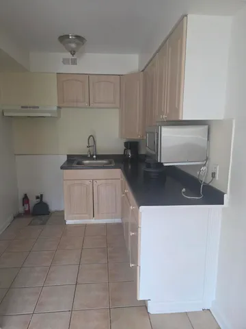 a kitchen with a sink a stove and cabinets