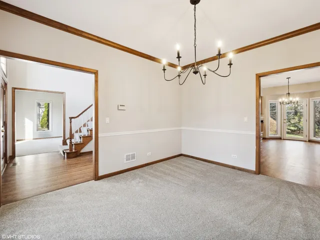 a view of a livingroom with wooden floor and a ceiling fan