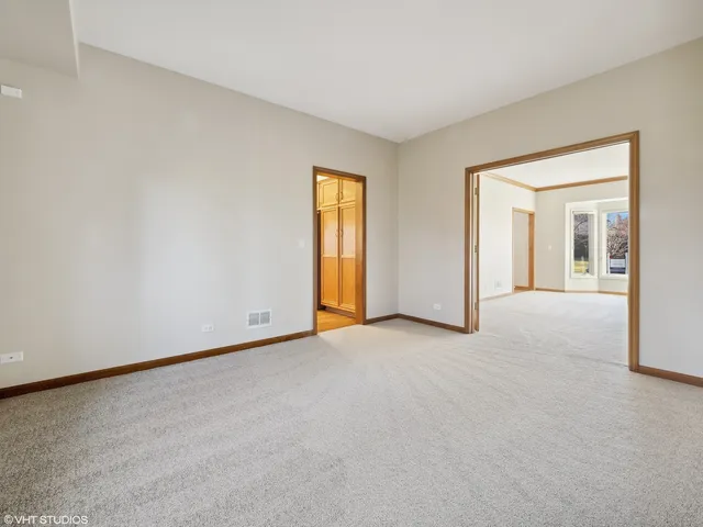 an empty room with windows and bathroom view