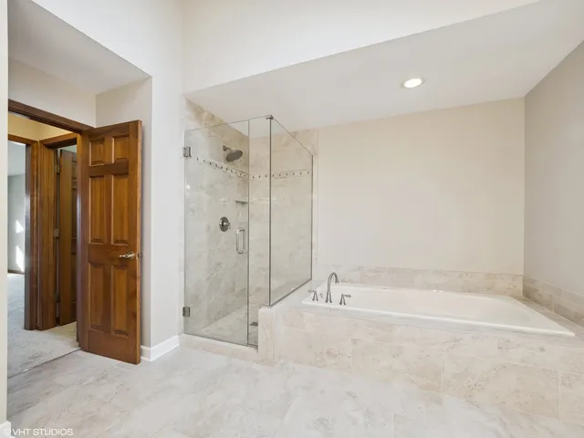 a large bathroom with a large mirror vanity sink and tub