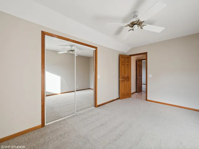an empty room with fan and windows