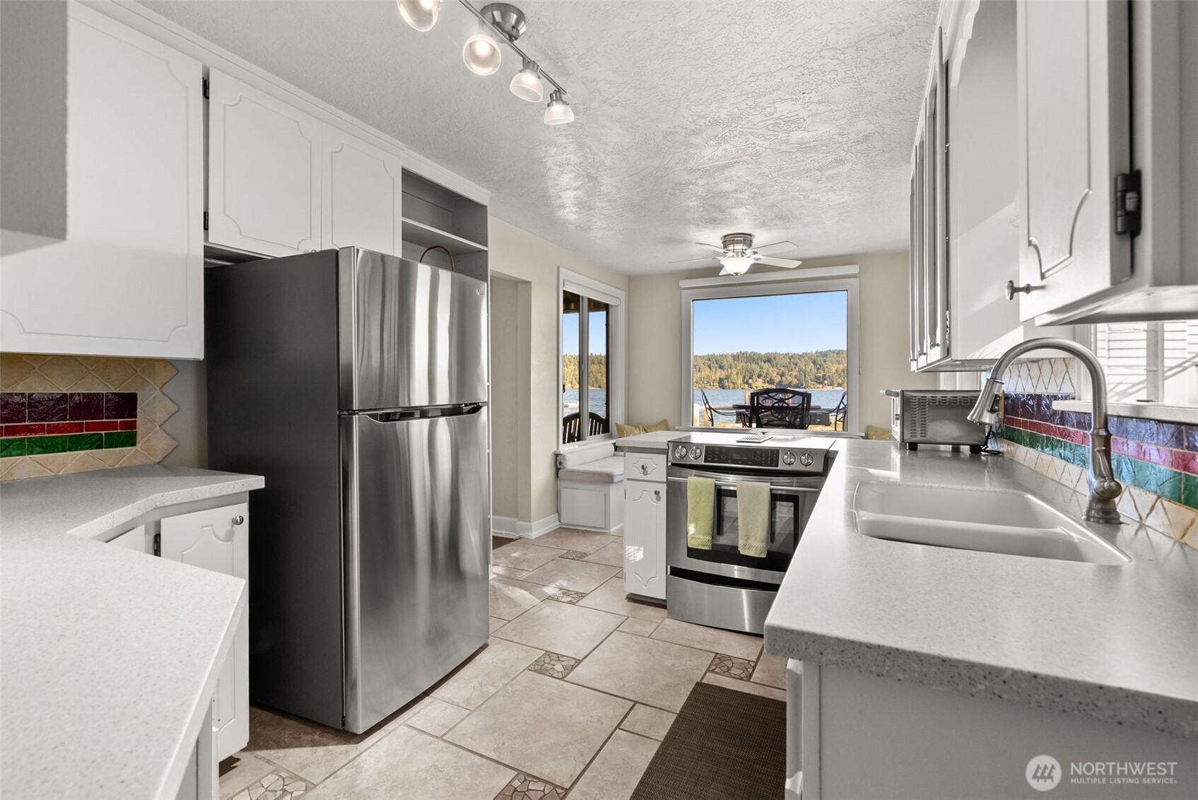 5208 Illahee Road Northeast Bremerton, WA 98311 - Photo 12 of 39 a kitchen with granite countertop a refrigerator and a sink