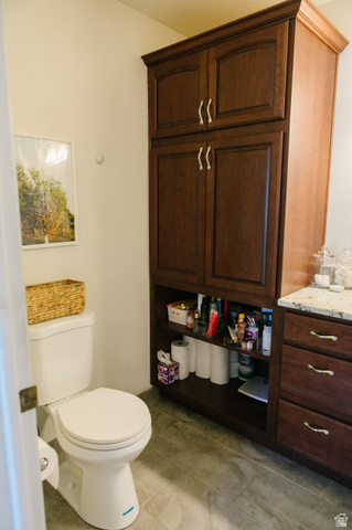 104 South Ridgeview Drive Orem, UT 84058 - Photo 23 of 49 Bathroom featuring a dark wood storage cabinet with upper and lower doors, an open shelving unit, and a matching vanity with drawers