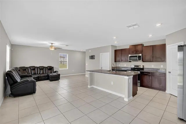 a kitchen with stainless steel appliances granite countertop a refrigerator and a sink