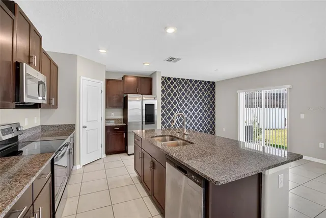 a kitchen with a stove a sink and a refrigerator