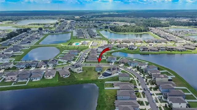 an aerial view of a swimming pool patio and outdoor seating