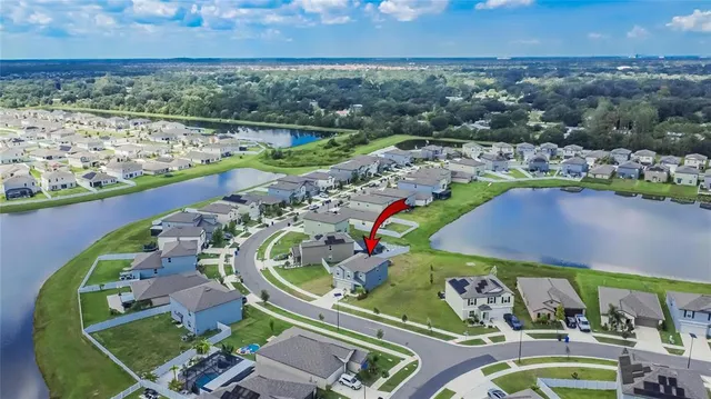 an aerial view of a house with a lake view