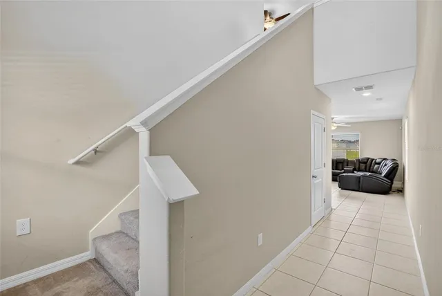 a view of a hallway with a livingroom and furniture
