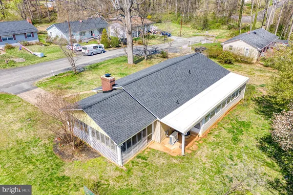 an aerial view of a house with a garden and swimming pool