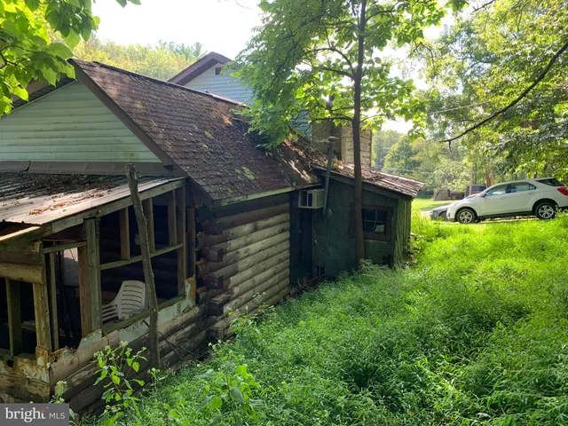 a backyard of a house with lots of green space and fountain