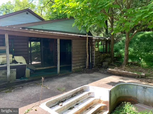 a backyard of a house with barbeque oven
