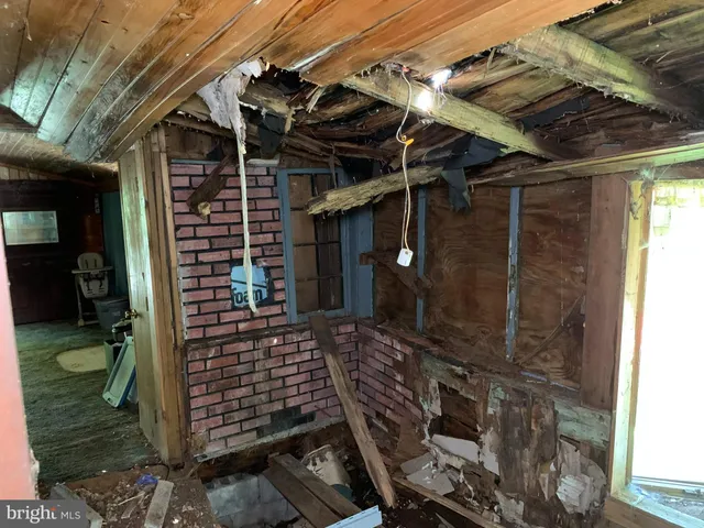 a utility room with wooden floor washer and dryer