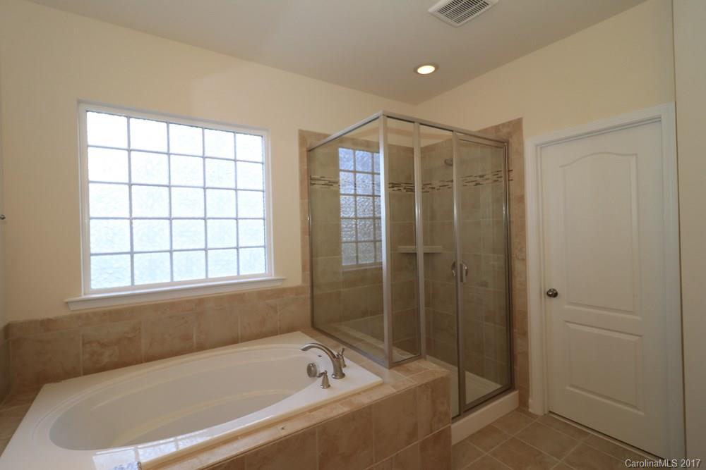 156 Hawks Creek Parkway, Unit 16 Fort Mill, SC 29708 - Photo 13 of 21 a bathroom with a bathtub and shower
