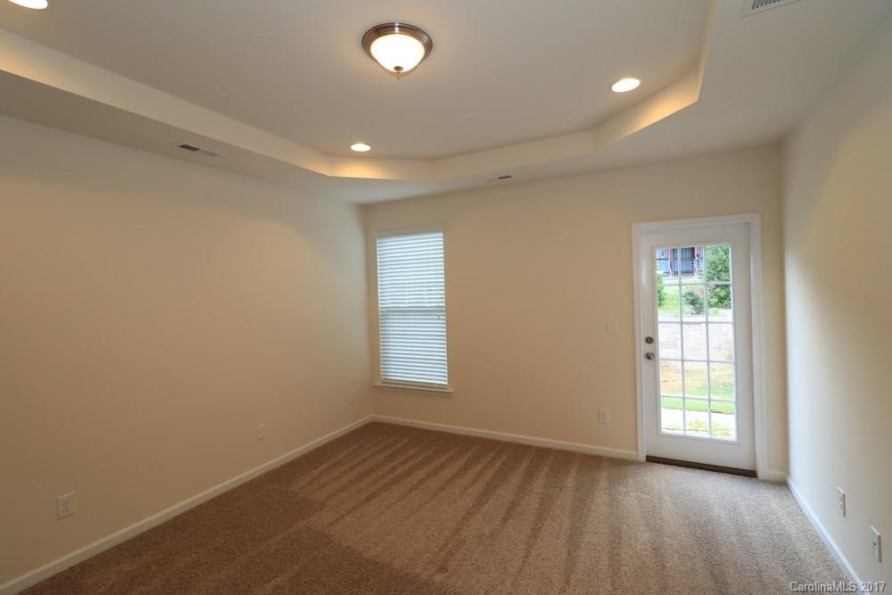 156 Hawks Creek Parkway, Unit 16 Fort Mill, SC 29708 - Photo 15 of 21 an empty room with wooden floor and windows