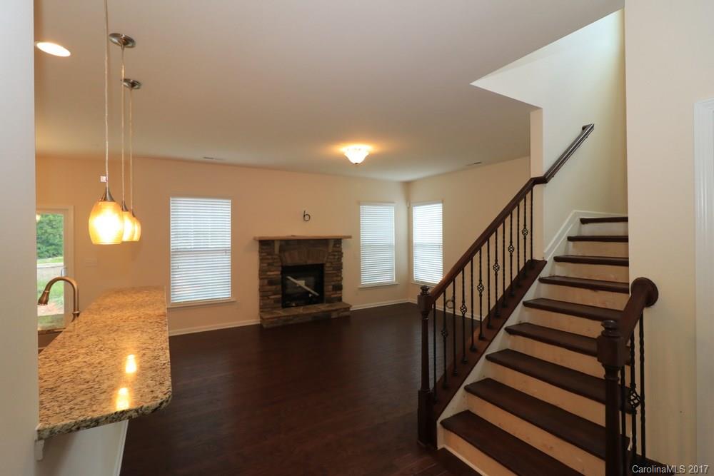 156 Hawks Creek Parkway, Unit 16 Fort Mill, SC 29708 - Photo 3 of 21 a view of a livingroom with wooden floor and a fireplace