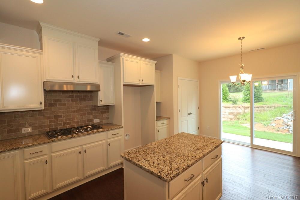 156 Hawks Creek Parkway, Unit 16 Fort Mill, SC 29708 - Photo 6 of 21 a kitchen with stainless steel appliances granite countertop a sink stove and refrigerator