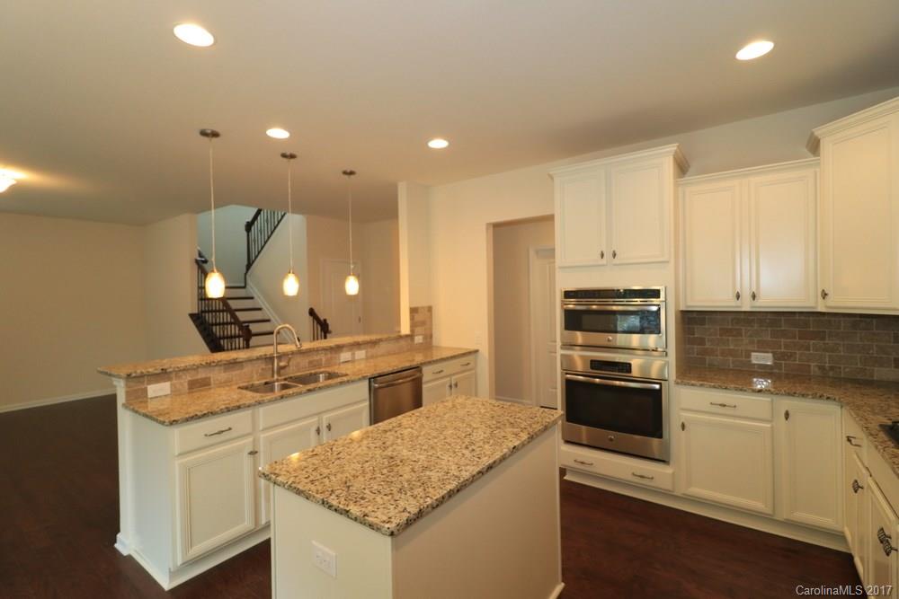 156 Hawks Creek Parkway, Unit 16 Fort Mill, SC 29708 - Photo 7 of 21 a kitchen with a sink stove and refrigerator