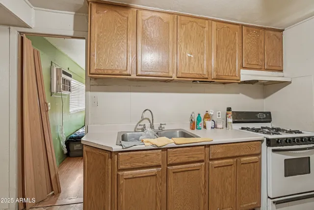 a kitchen with stainless steel appliances granite countertop a sink stove and cabinets
