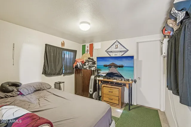 a bedroom with a bed and a tv in it