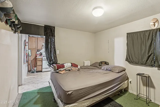 a bedroom with a bed and a wall painting