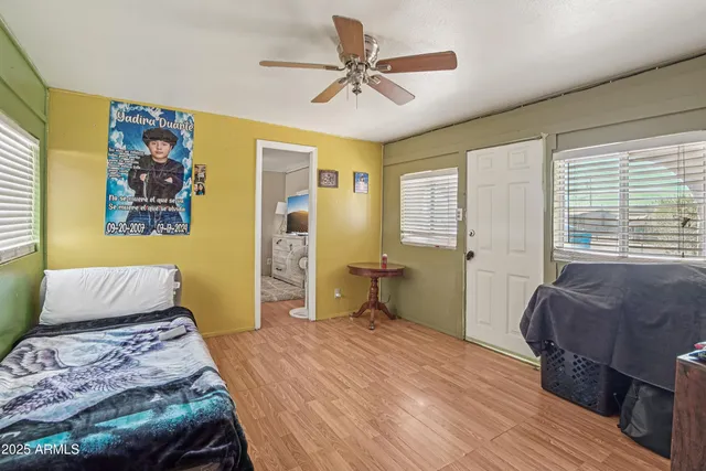 a bedroom with a bed and wooden floor