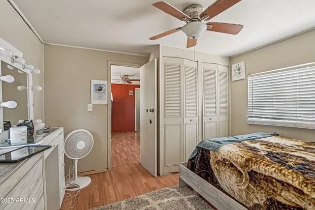 a bedroom with a bed and a chandelier