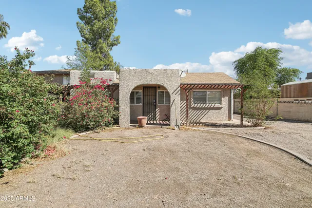 a front view of a house with a yard and a garage