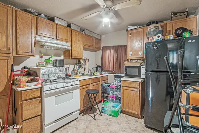 a kitchen with stainless steel appliances a refrigerator sink and cabinets