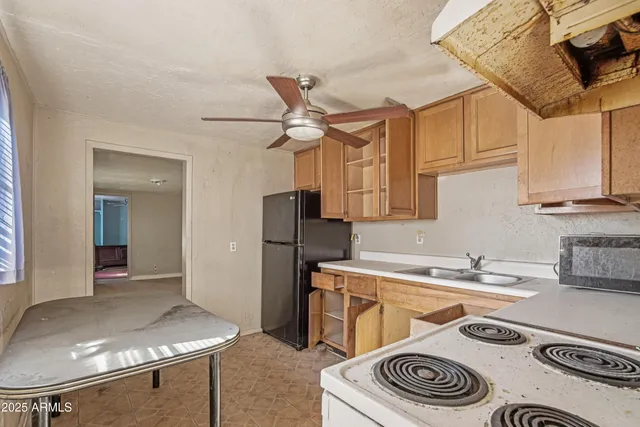 a kitchen with a appliances and cabinets