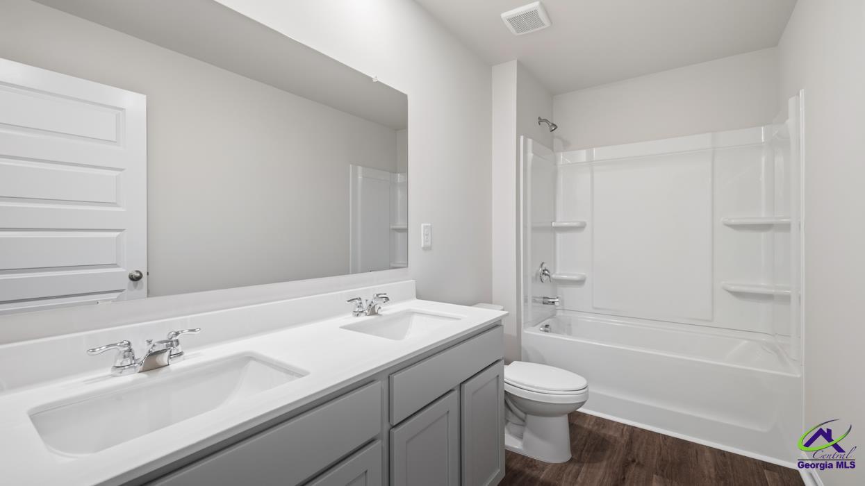 227 Cattle Drive Perry, GA 31069 - Photo 34 of 40 a bathroom with a sink a toilet and shower