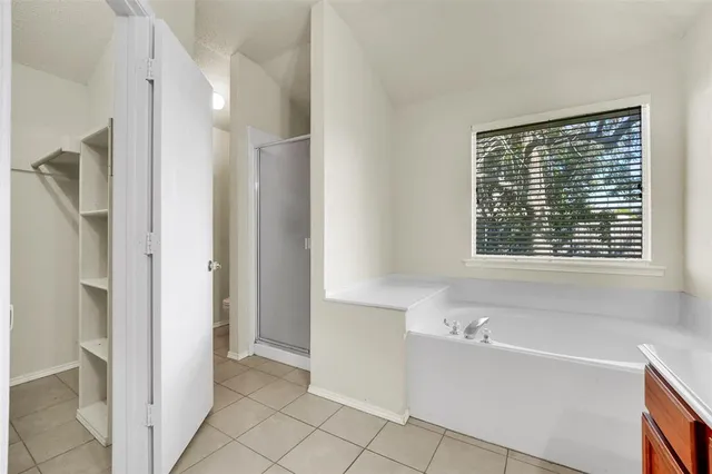 a bathroom with a bathtub and a shower