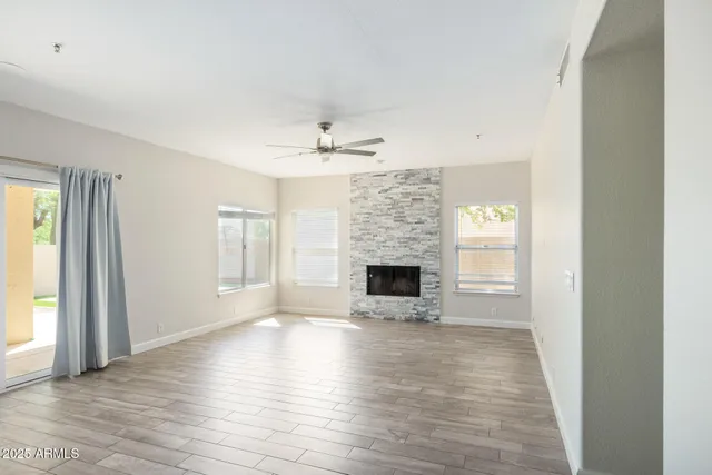 a view of empty room with wooden floor and fireplace