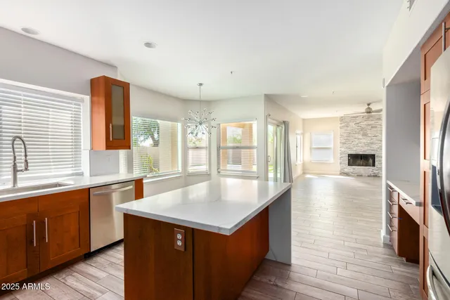 a kitchen with stainless steel appliances granite countertop a sink and a refrigerator