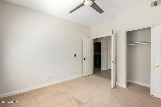 an empty room with closet and a bathroom