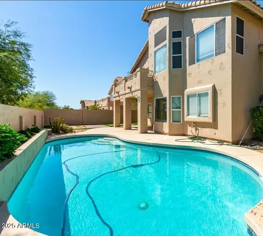 a view of house with swimming pool yard and outdoor seating