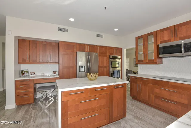 a kitchen with a dining table chairs and view of living room
