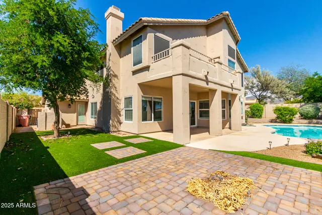 a front view of a house with a yard and trees