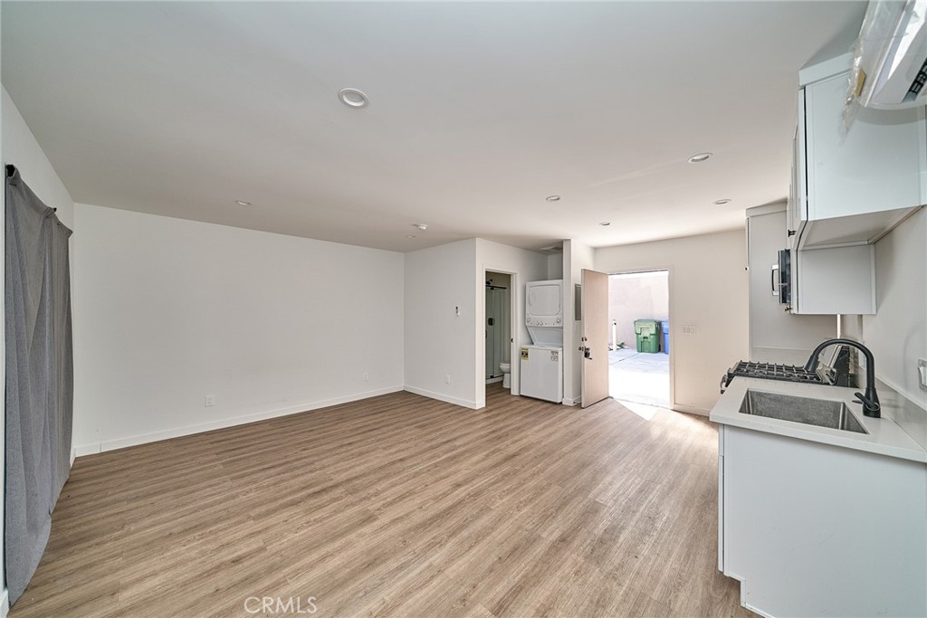 8734 1/2 Ramsgate Avenue Westchester, CA 90045 - Photo 2 of 6 a view of a kitchen with a sink and dishwasher wooden floor