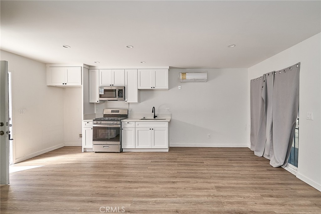 8734 1/2 Ramsgate Avenue Westchester, CA 90045 - Photo 5 of 6 a kitchen with stainless steel appliances a refrigerator and a stove top oven